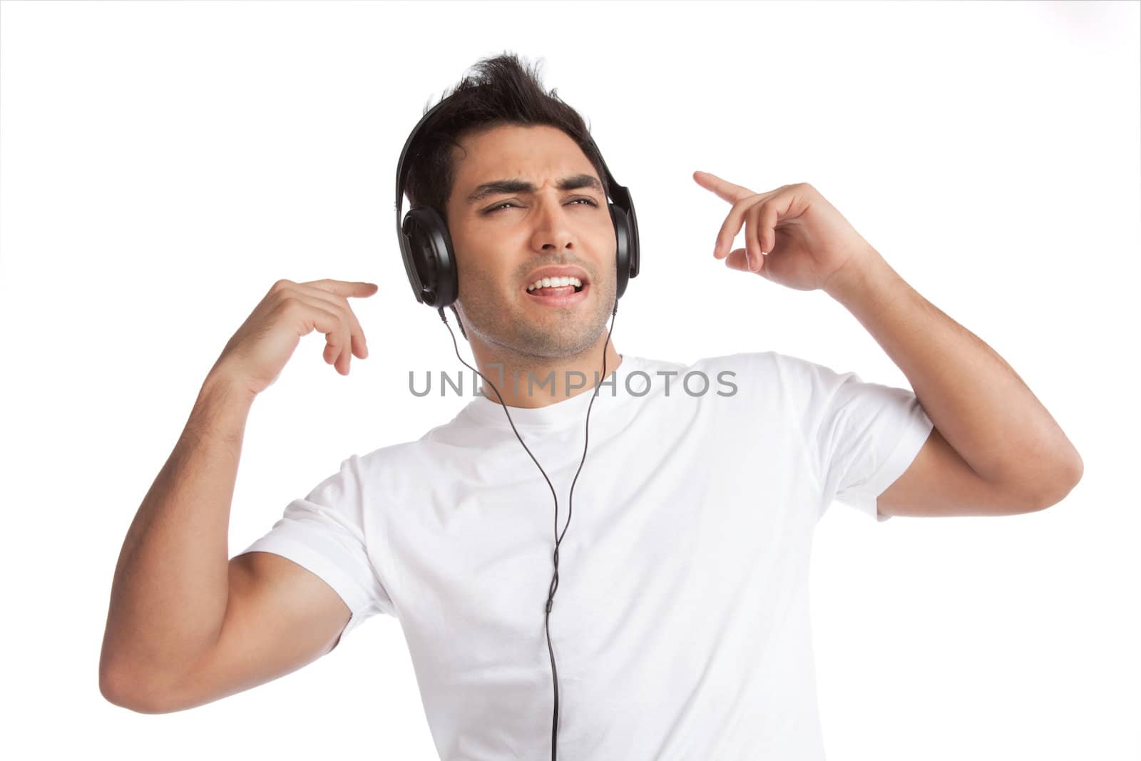 Portrait of young man listening music on headphone isolated on white background.