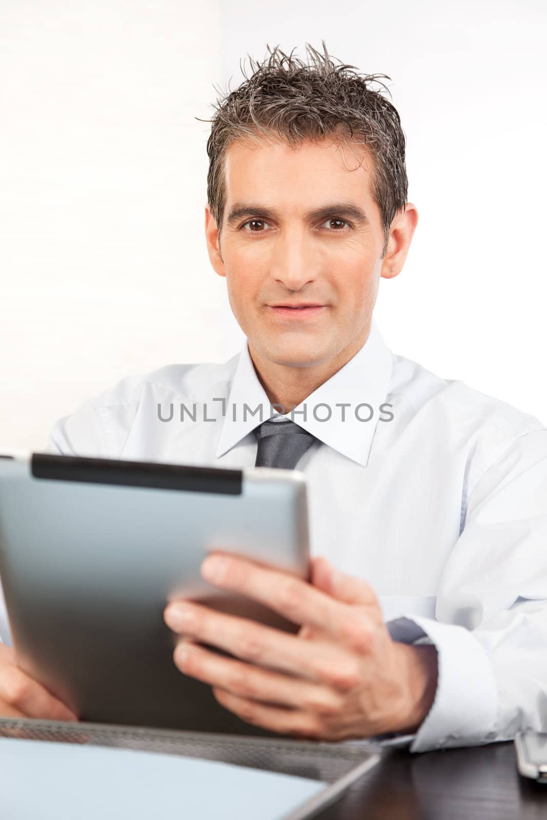 Businessman Holding Digital Tablet by leaf