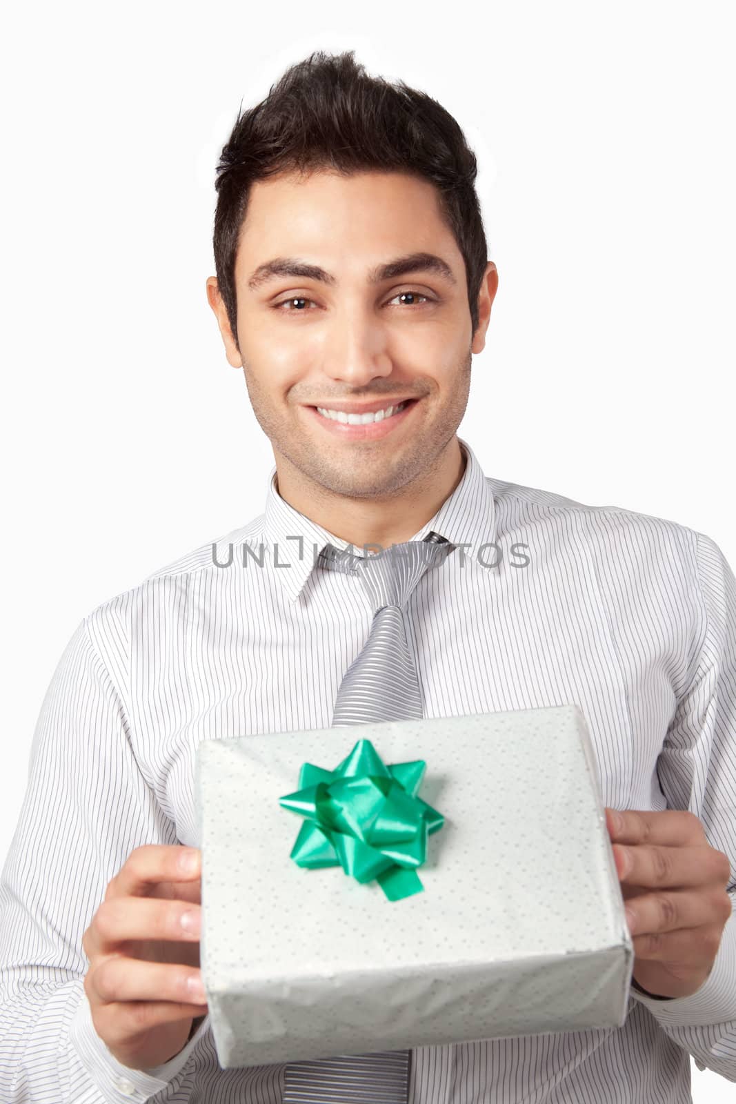 Happy young businessman  holding gift box isolated on white background.