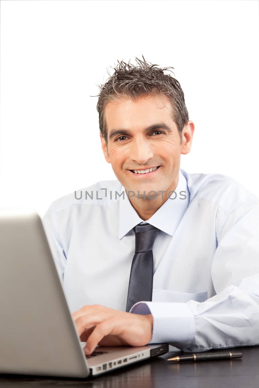 Businessman using laptop at work in office isolated on white background.
