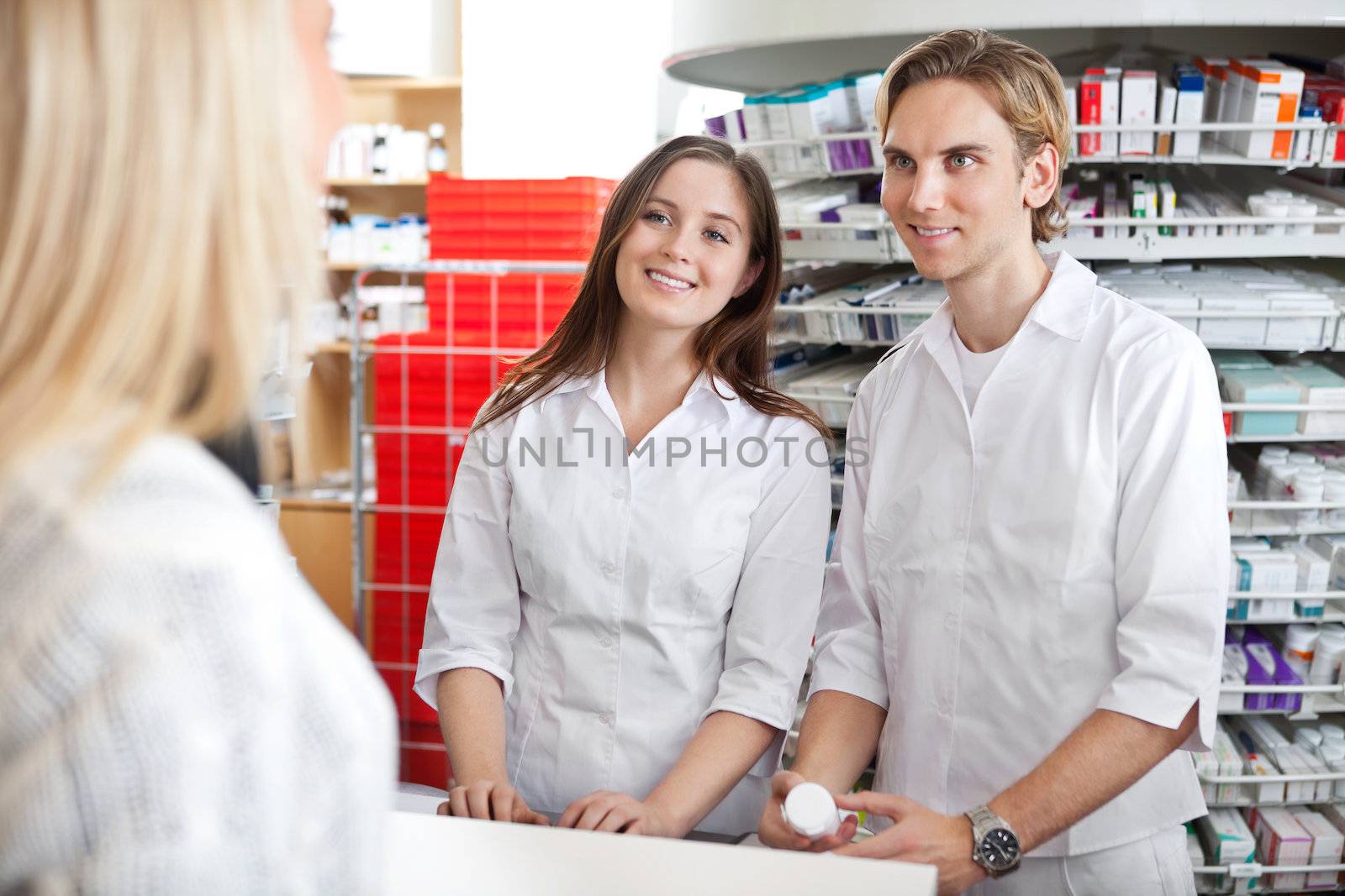 Pharmacists with Customer in Store by leaf