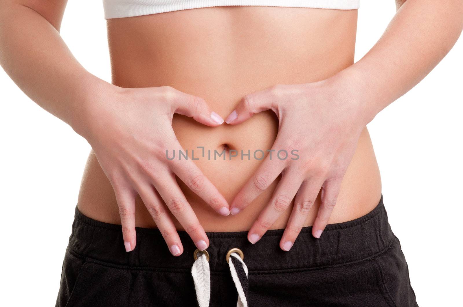 Woman making a heart symbol over her tummy with her hands, isolated in white