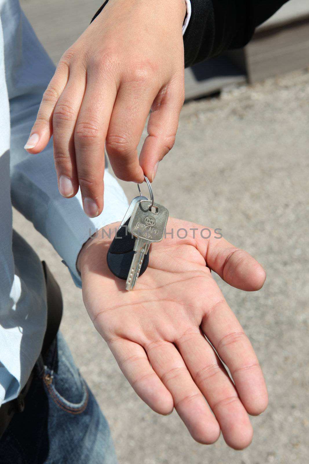 Saleswoman handing key to man