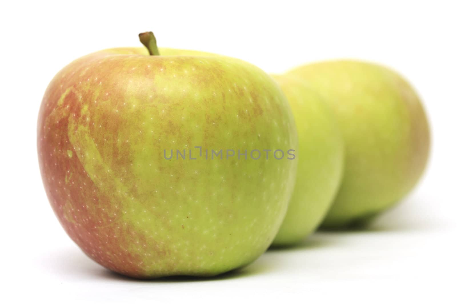 row of three apples  by schankz