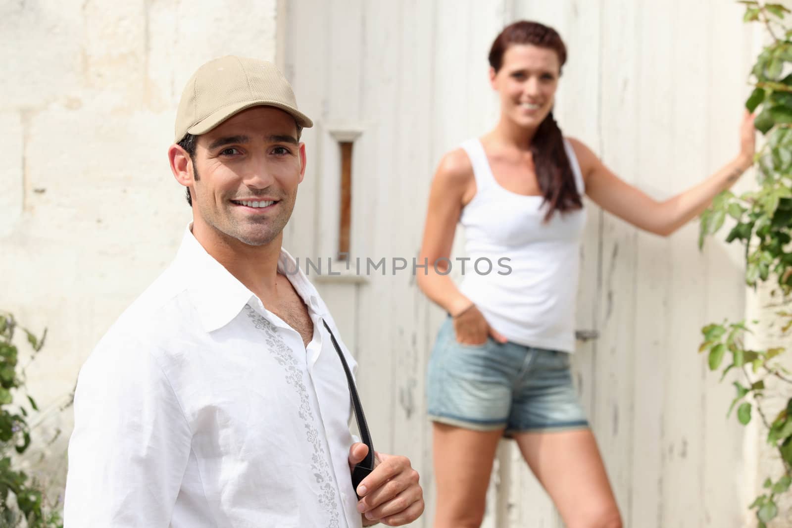 Couple outside a house in the summer