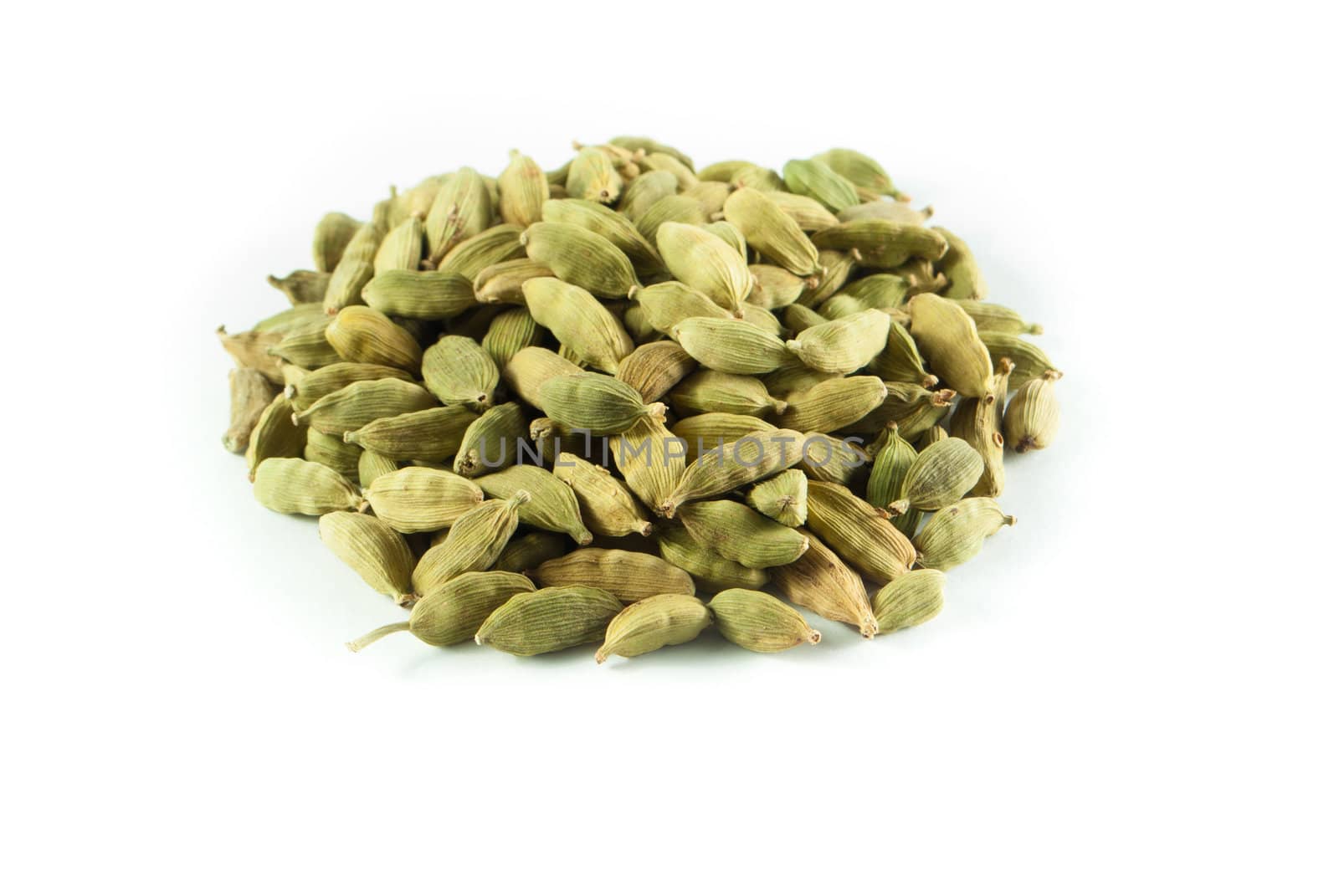 Pile of whole cardamom on white background