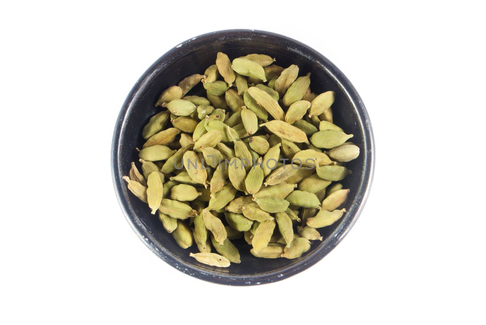 Pile of whole cardamom on white background