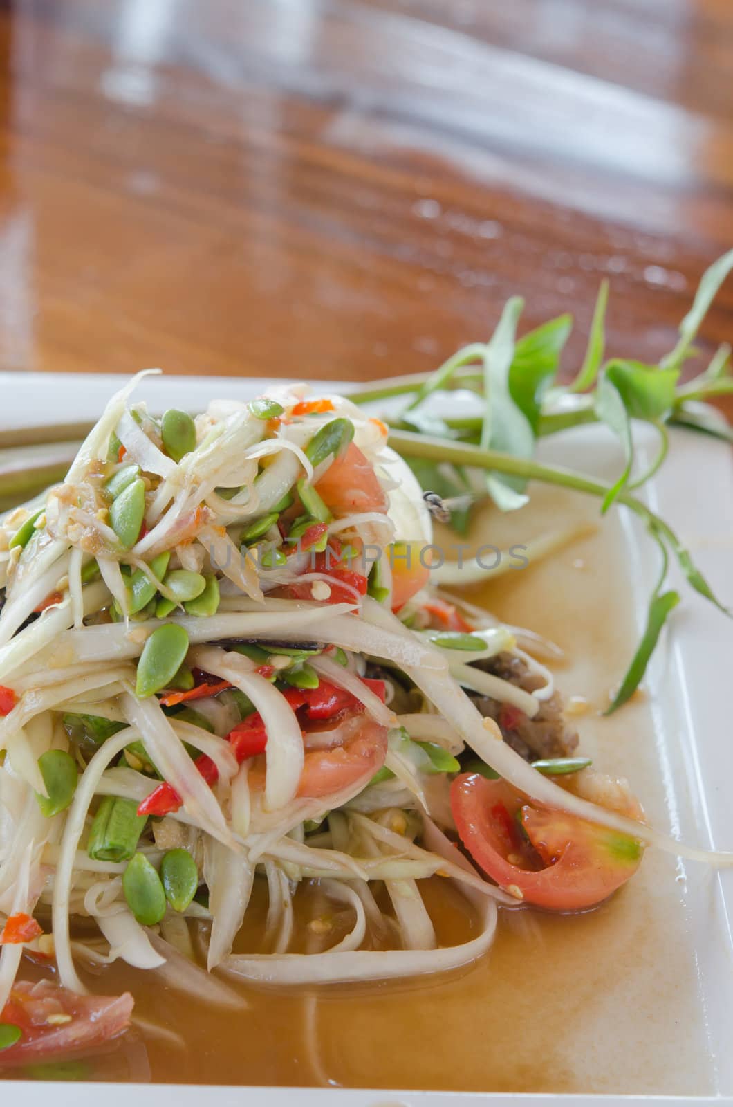 thai food, spicy papaya salad  with mixed vegetable on  dish