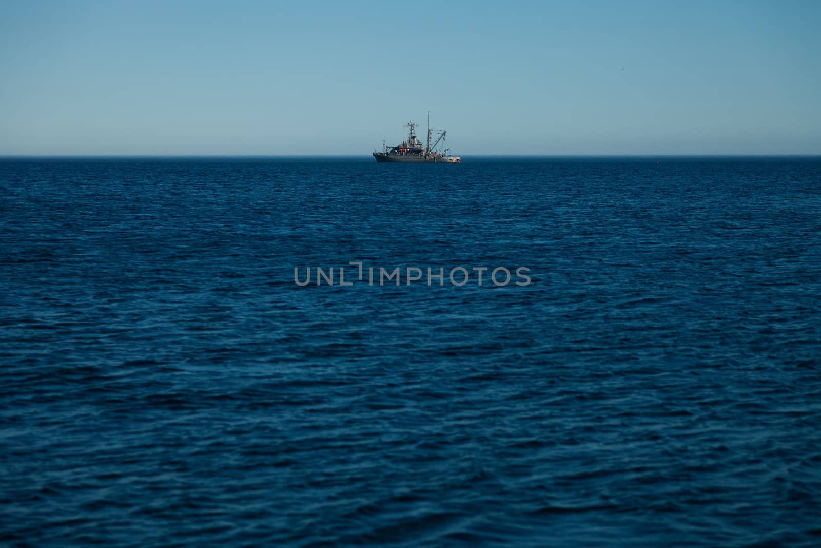 Far away Canadian army ship in the ocean