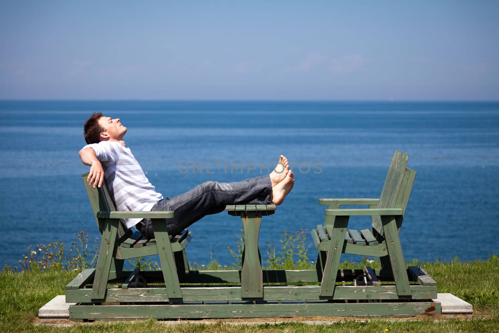 Man having a beautiful moment on a bench in vacation