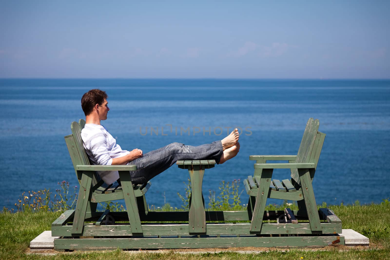 Young man sitting on the bench by aetb