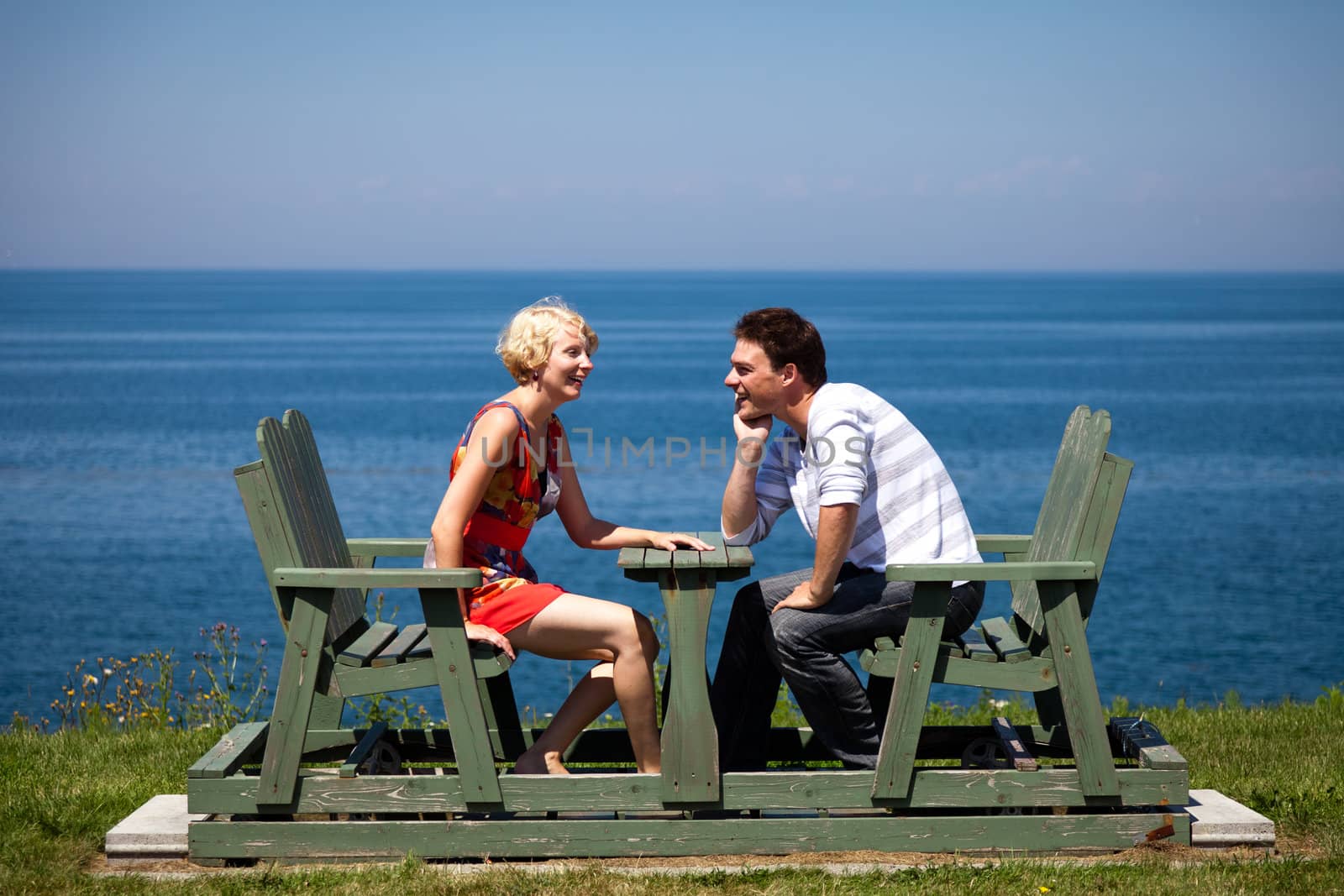 Romantic couple laughing together on the bench