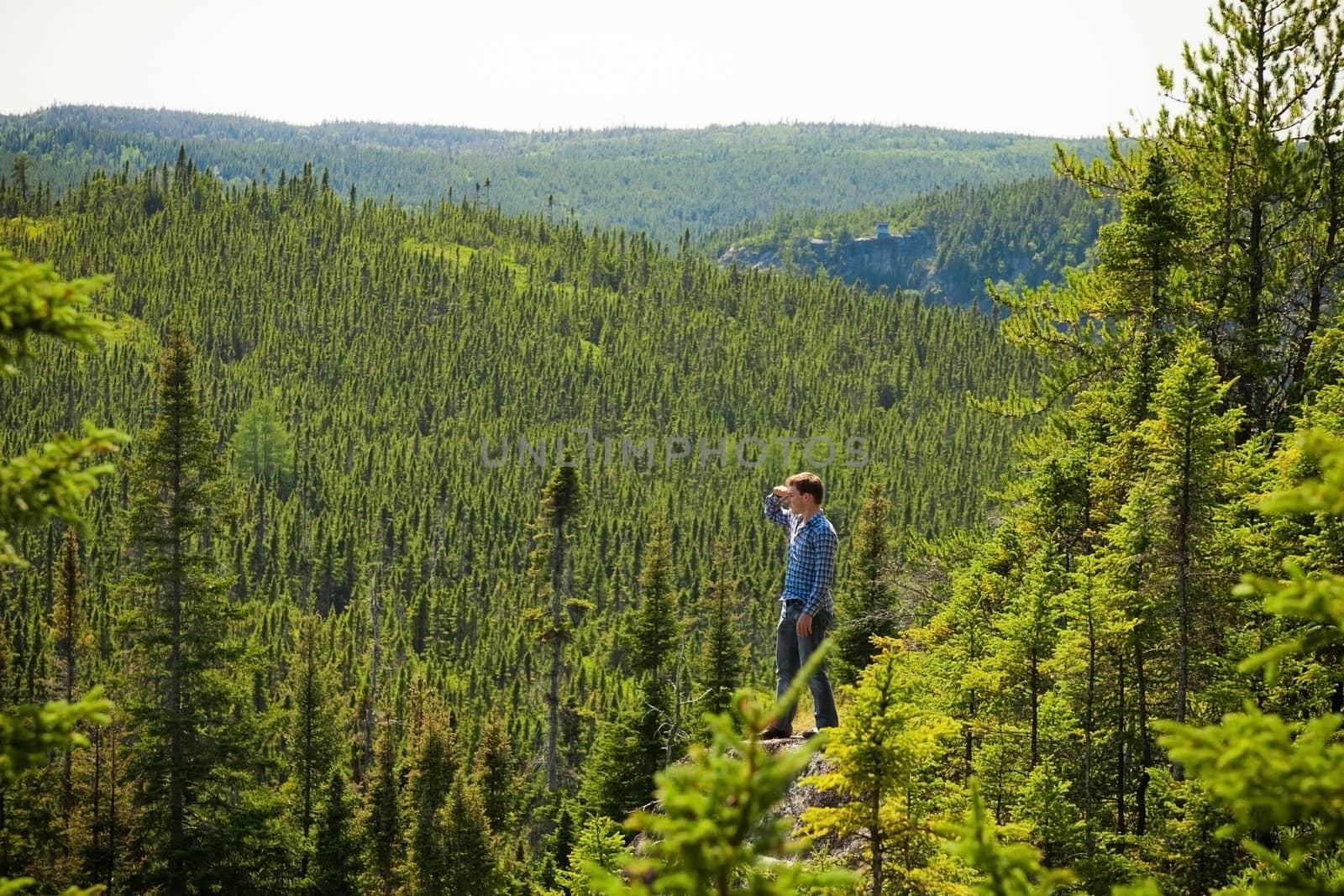 Young man on a rock in the middle of the nature by aetb