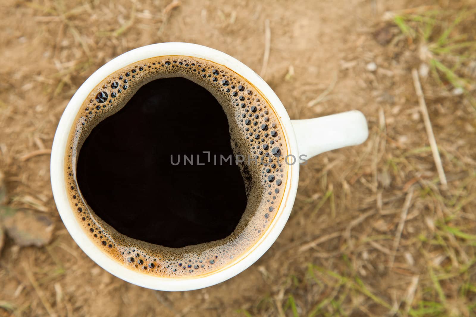 Close-up cup of fresh coffee on the ground