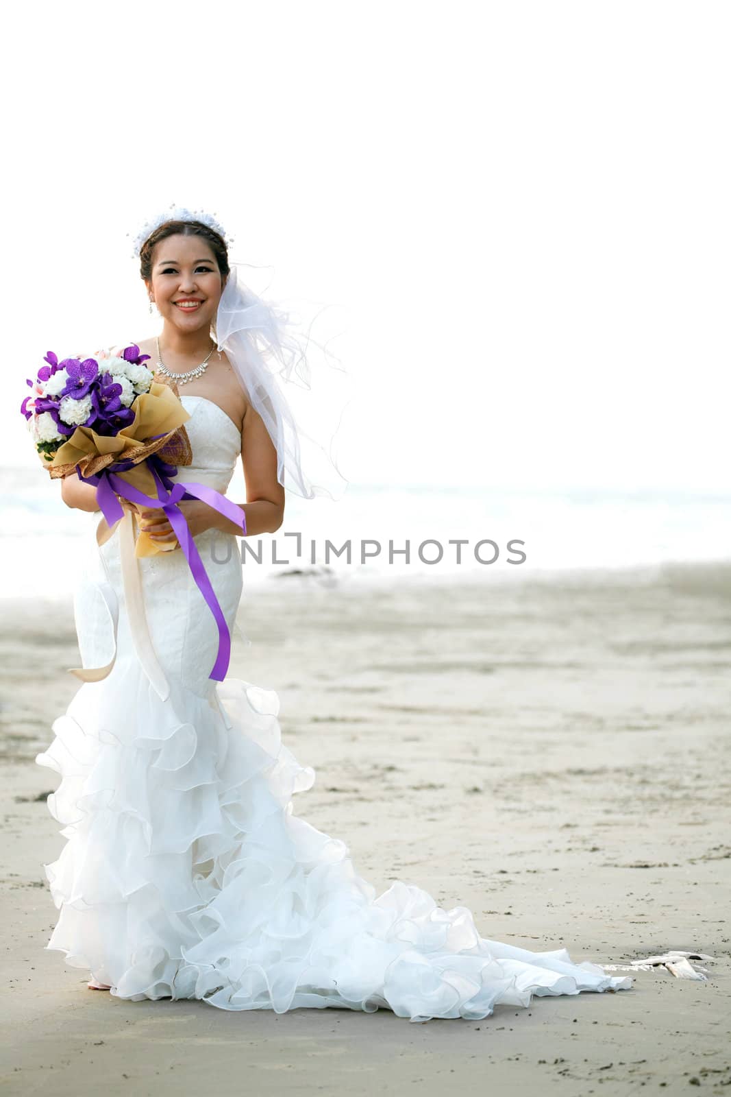 bride with flower bouquet on the beach by vichie81