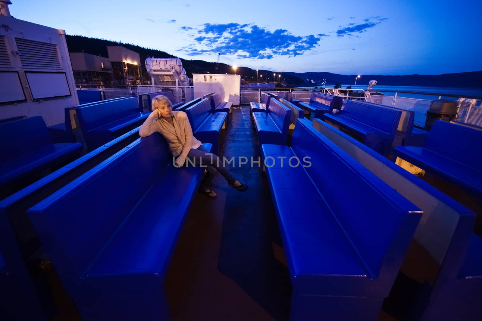 Girl sitting on the deck, the evening