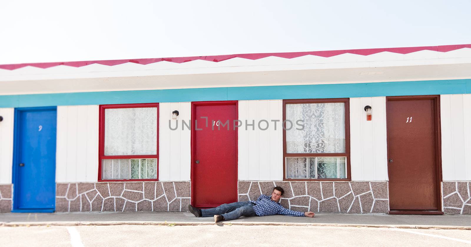 Motel and a man lying near the door