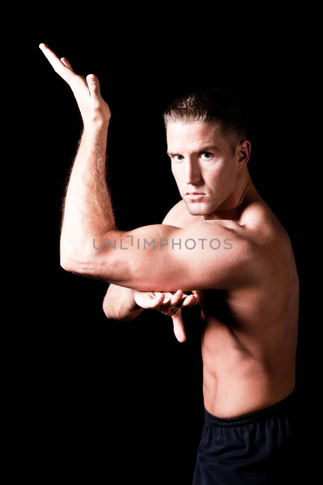 Muscular man isolated on black background