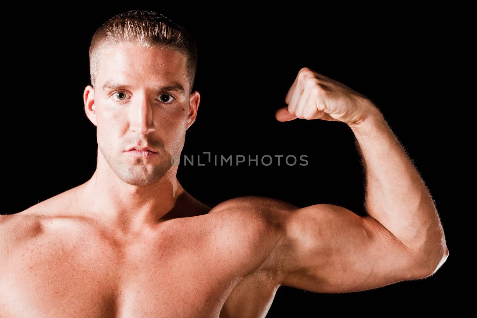 Muscular man isolated on black background