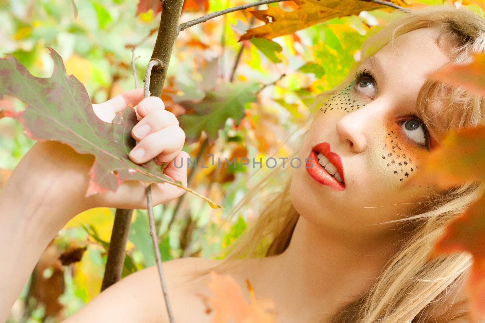 Happy teenager in a forest in the autumn