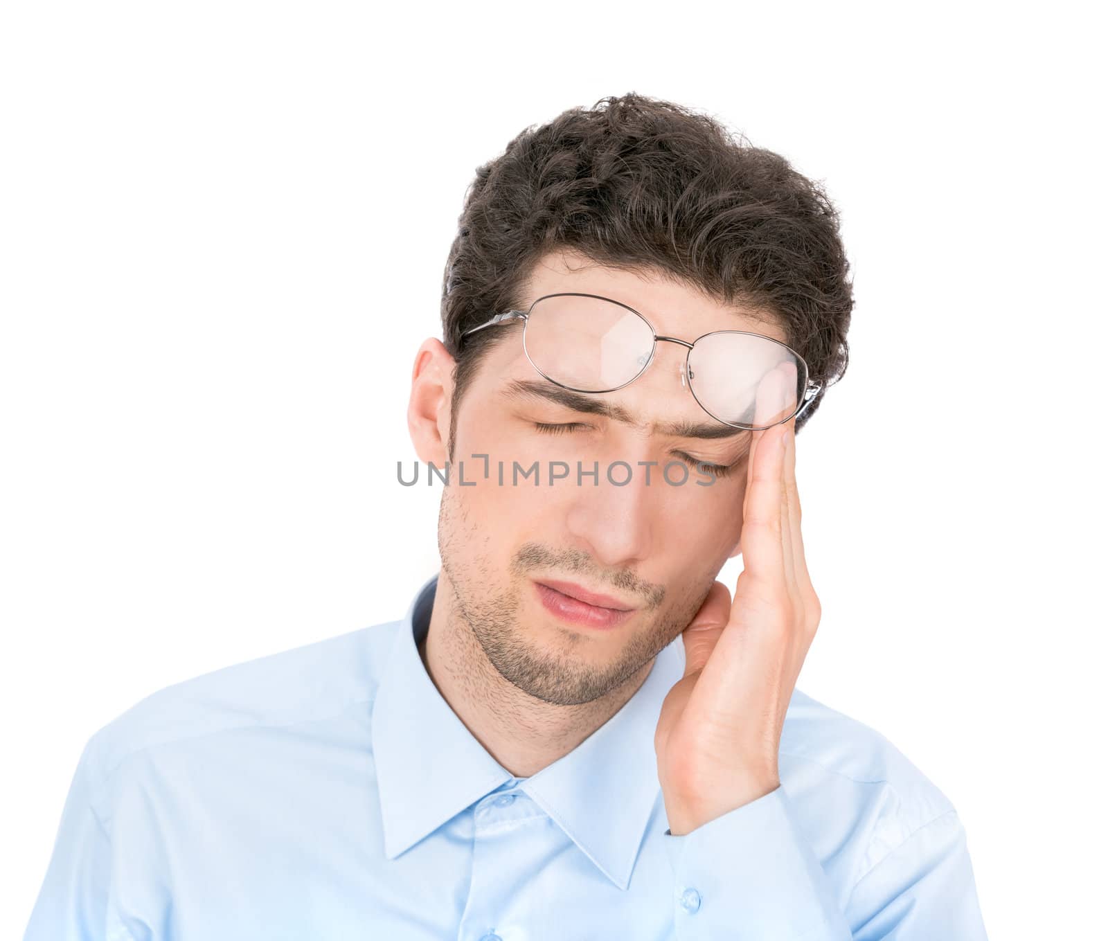 Handsome young businessman suffers from a headache. Isolated on white background.