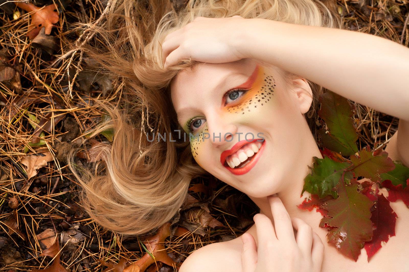 Happy teenager in a forest in the autumn