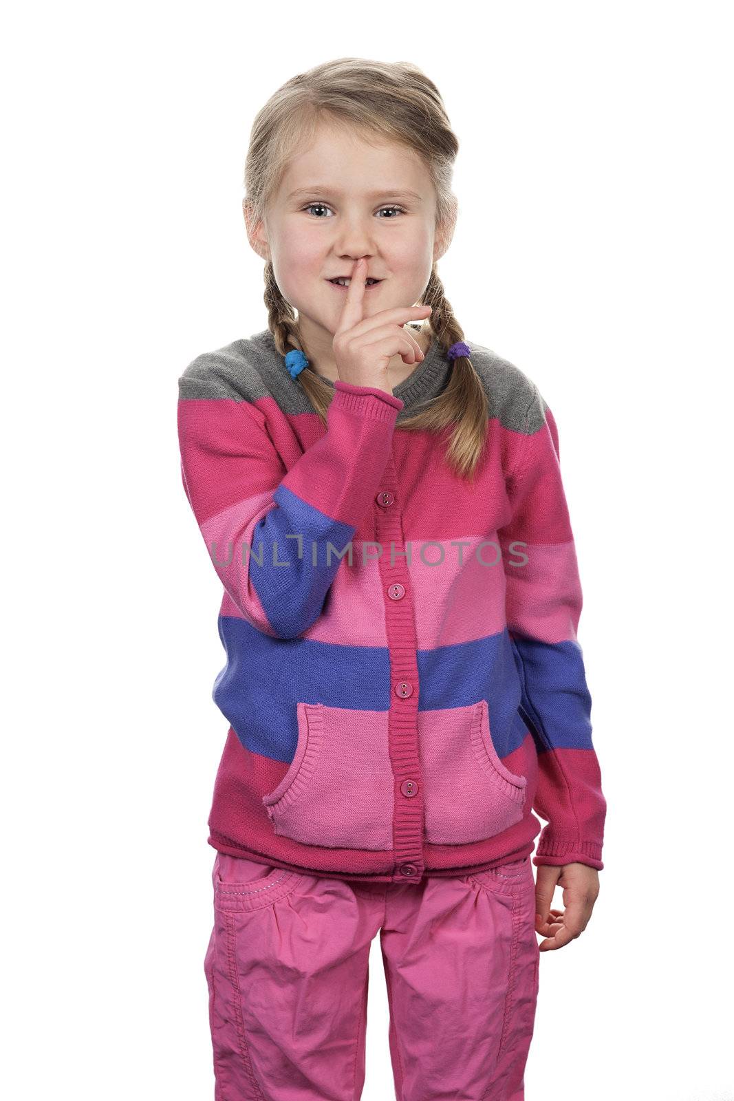 Portrait of cute girl with silence gesture over white background