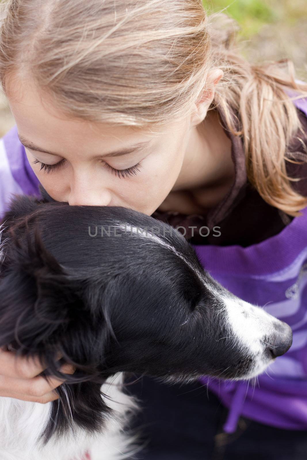 Close up of a pretty girl hugging a dog.