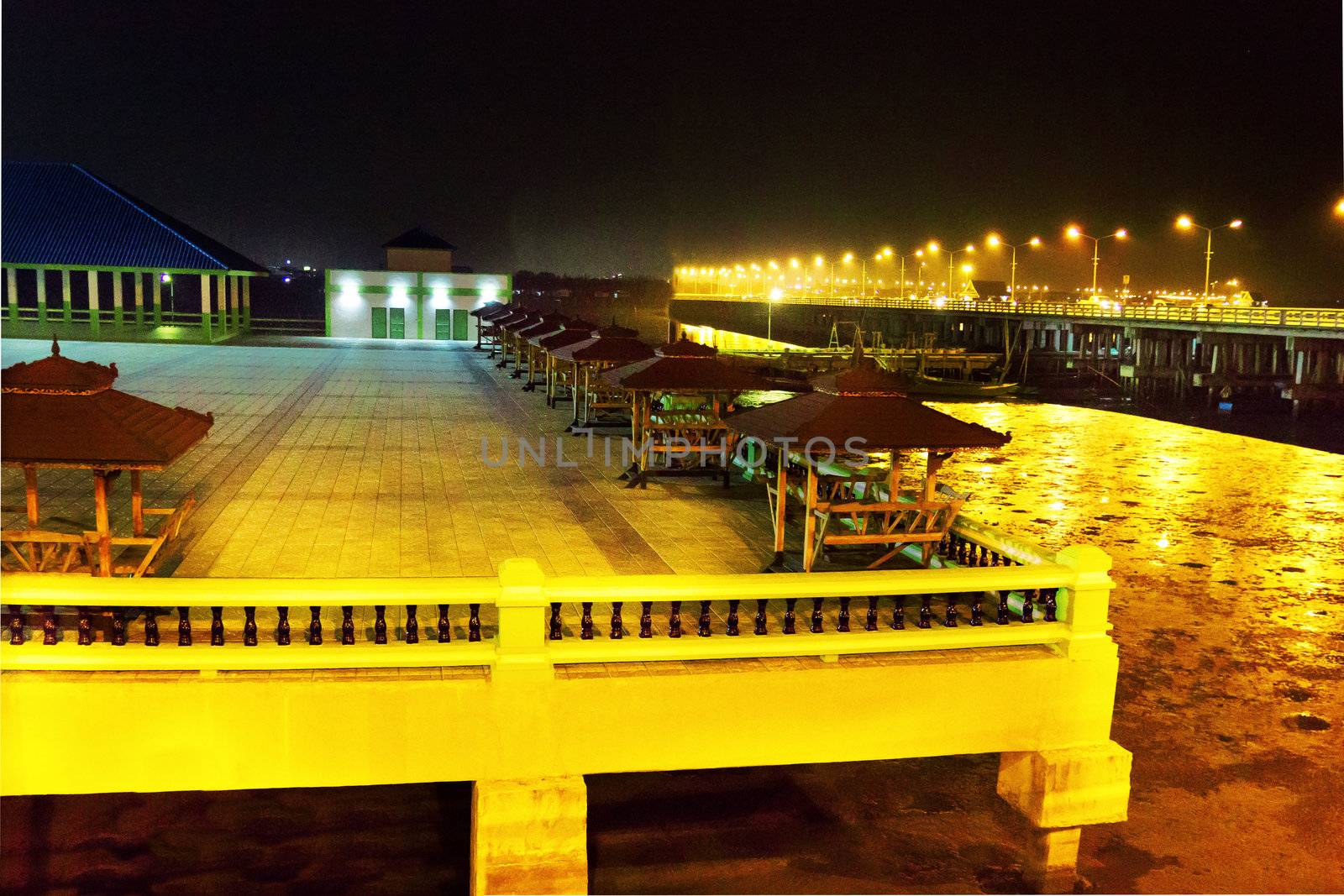 Fishing pier at night in thailand By The Sea by sutipp11