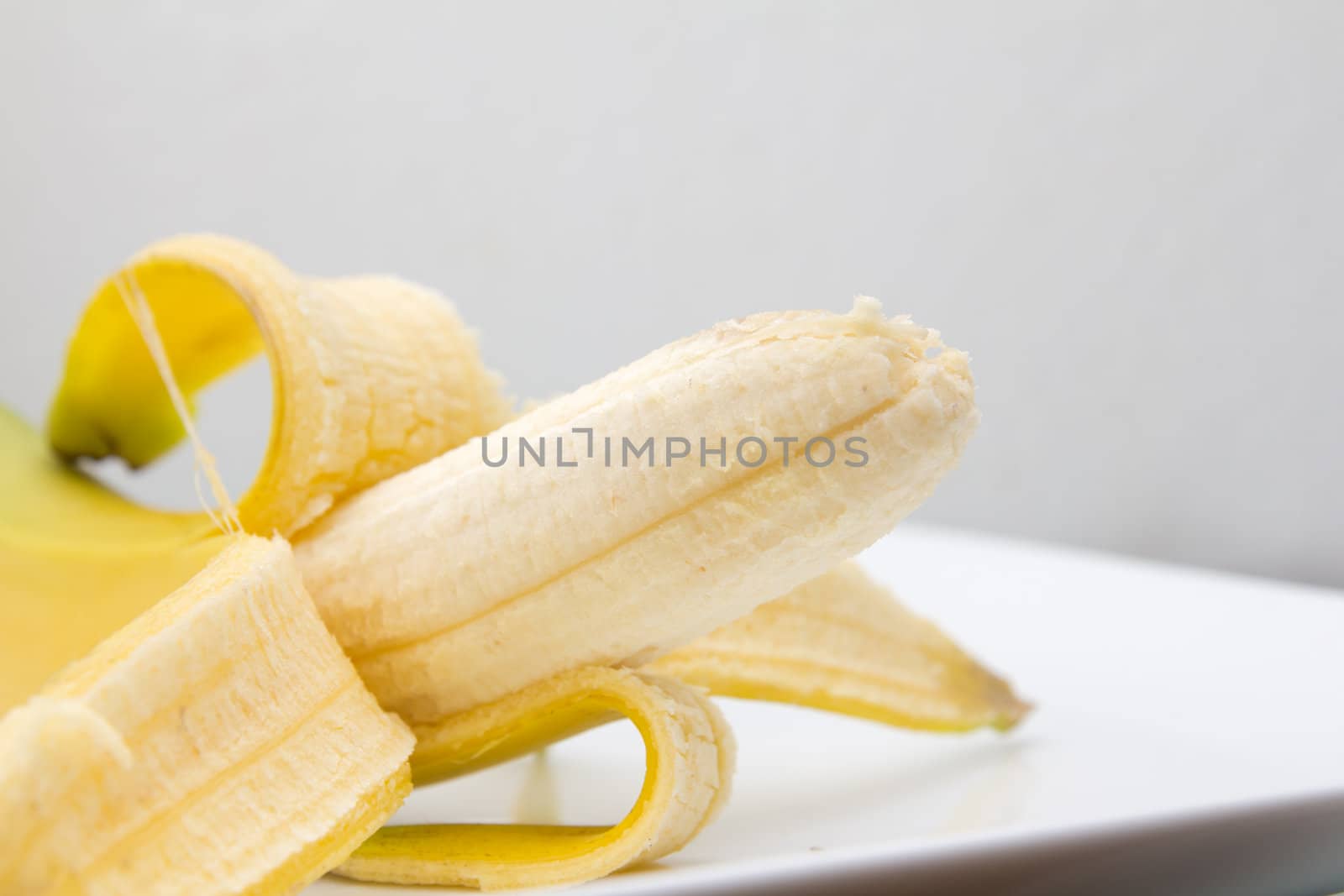 Close up of fresh banana over white background  by schankz