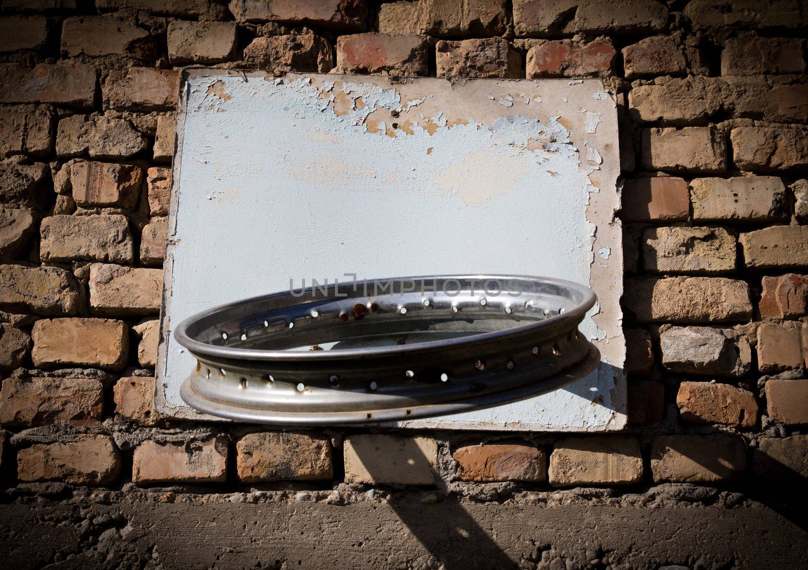 Self-made ring for basketball on a brick wall