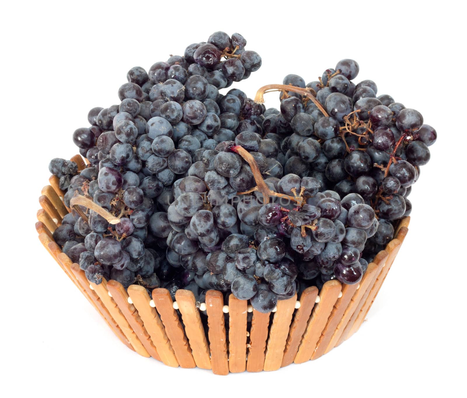 black grapes in a basket on a white background by schankz