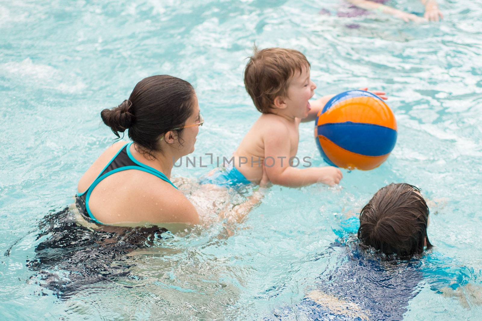 Family playing in the pool by Talanis