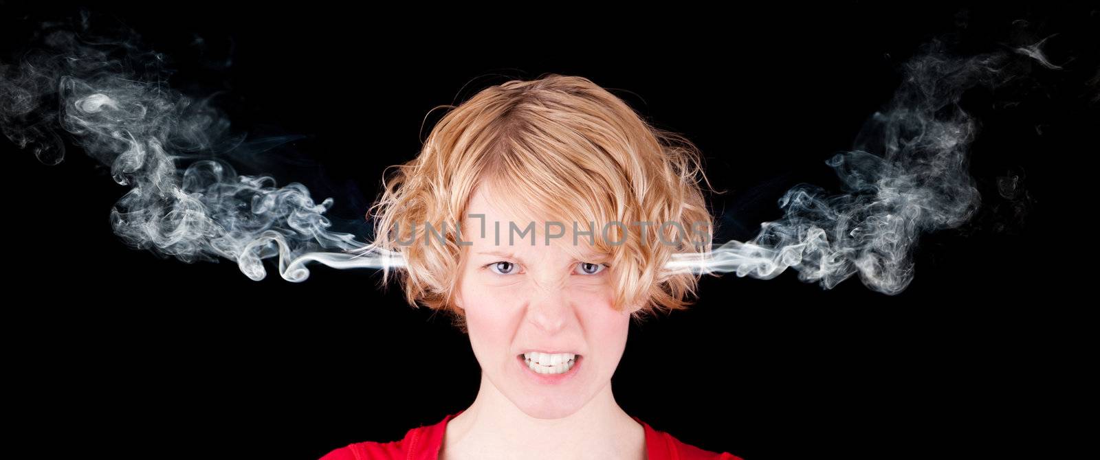 Very angry woman with smoke isolated on black background