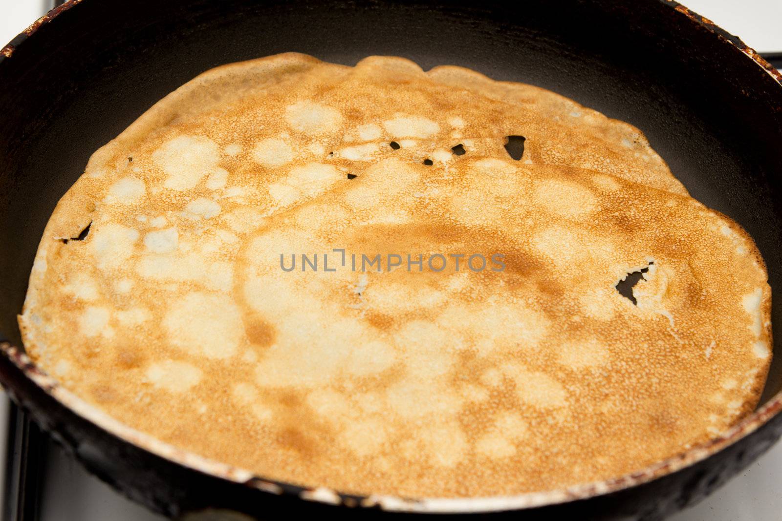 Frying a pancake cooking in a pan 