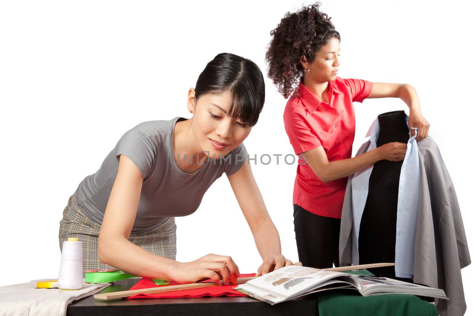Two young woman dressmaker at work.