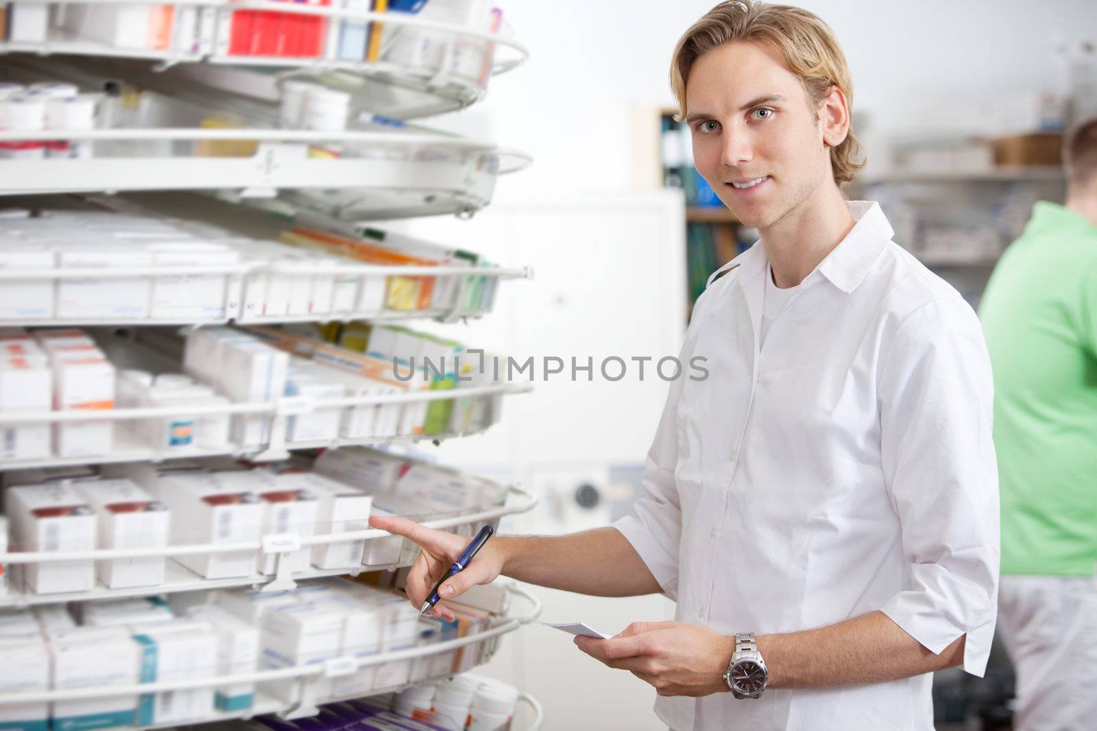 Portrait of male pharmacist working at pharmacy