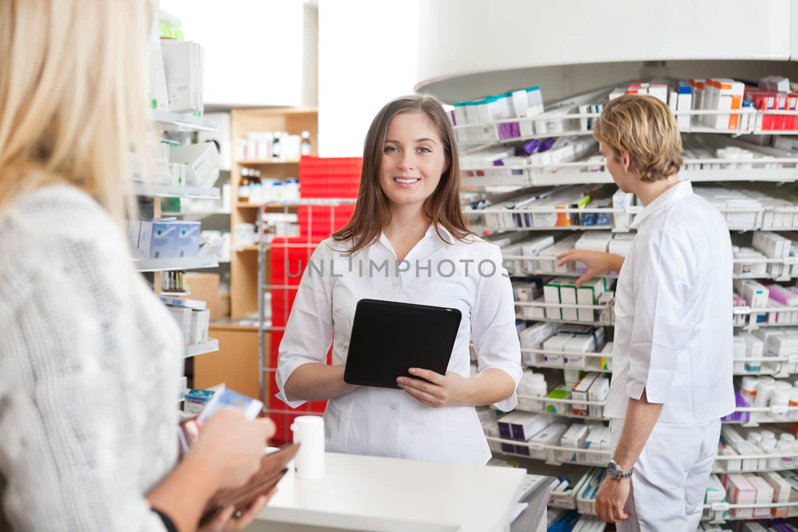 Female Pharmacist Holding Tablet PC by leaf