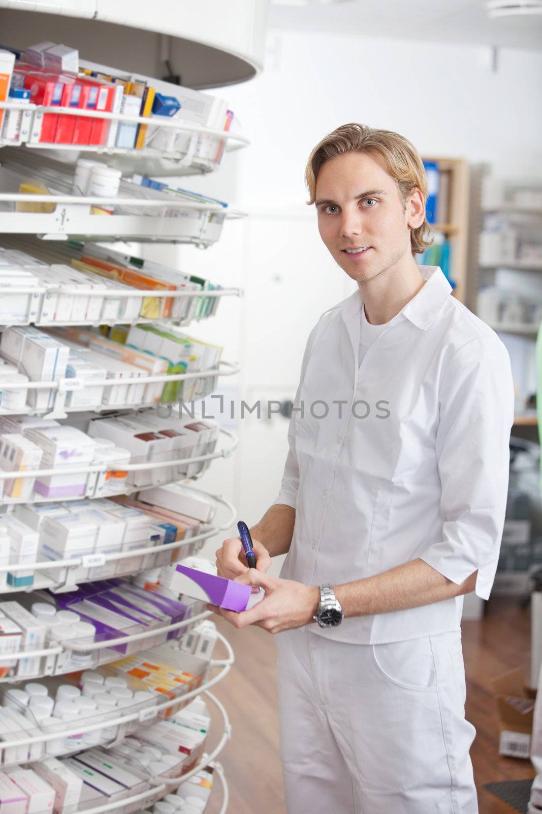 Male Pharmacist Working at Drugstore by leaf