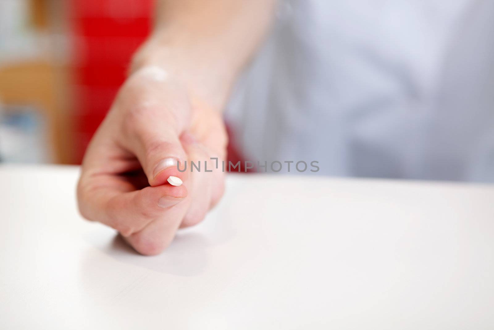 Hand Of Pharmacist Holding Medicine Pill by leaf