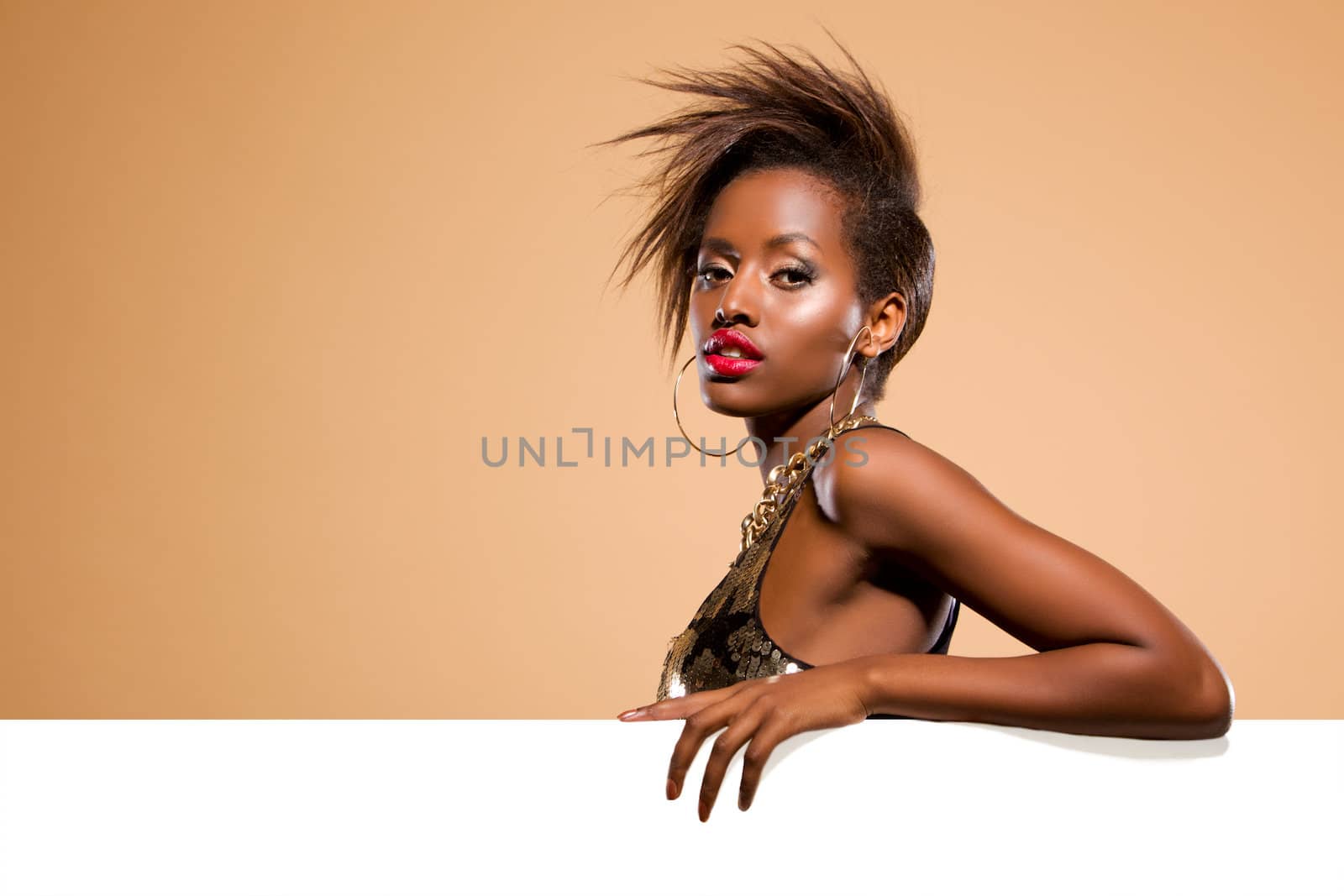 Attractive black woman model standing behind large white banner