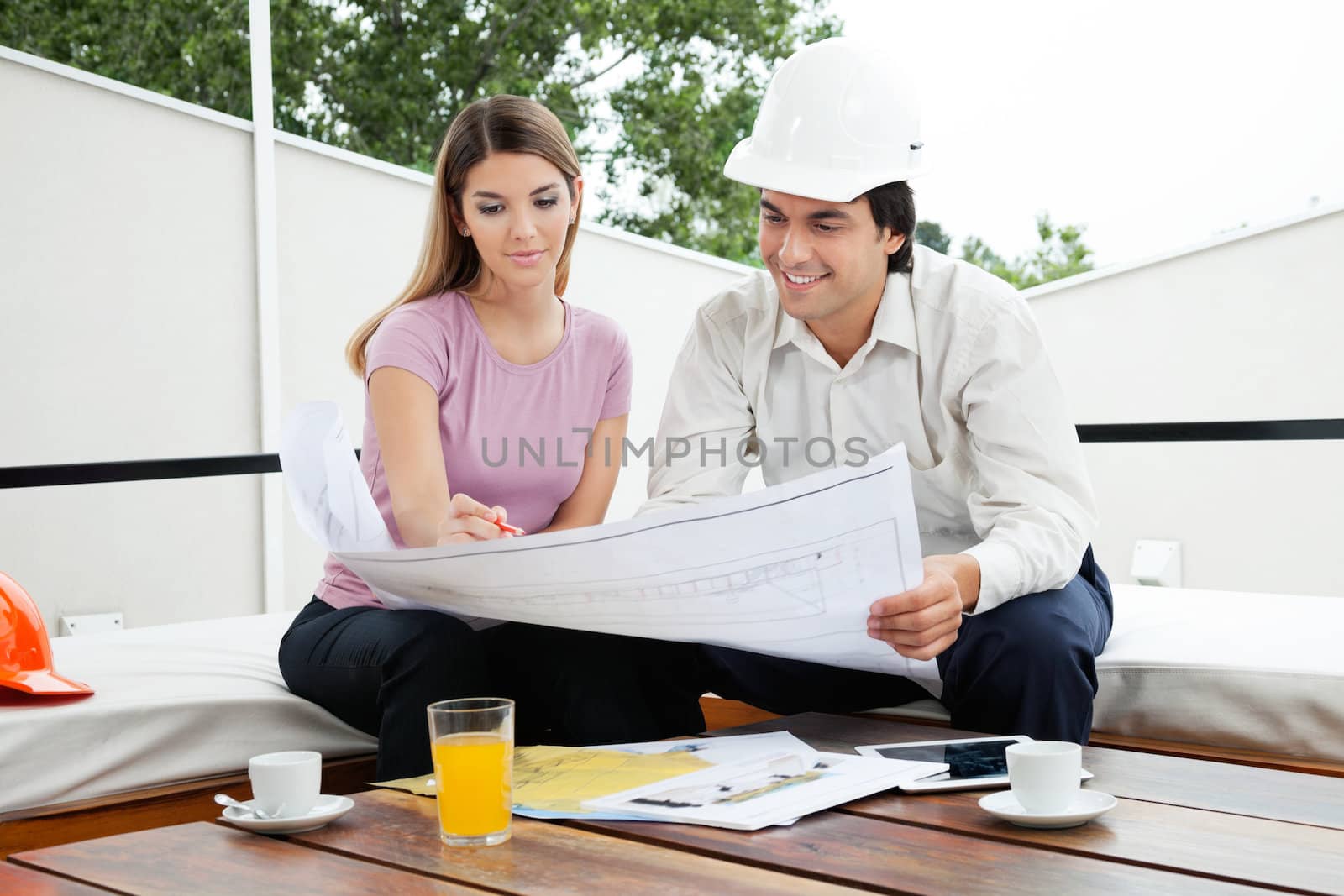 Young male architect having a discussion about house plans with female