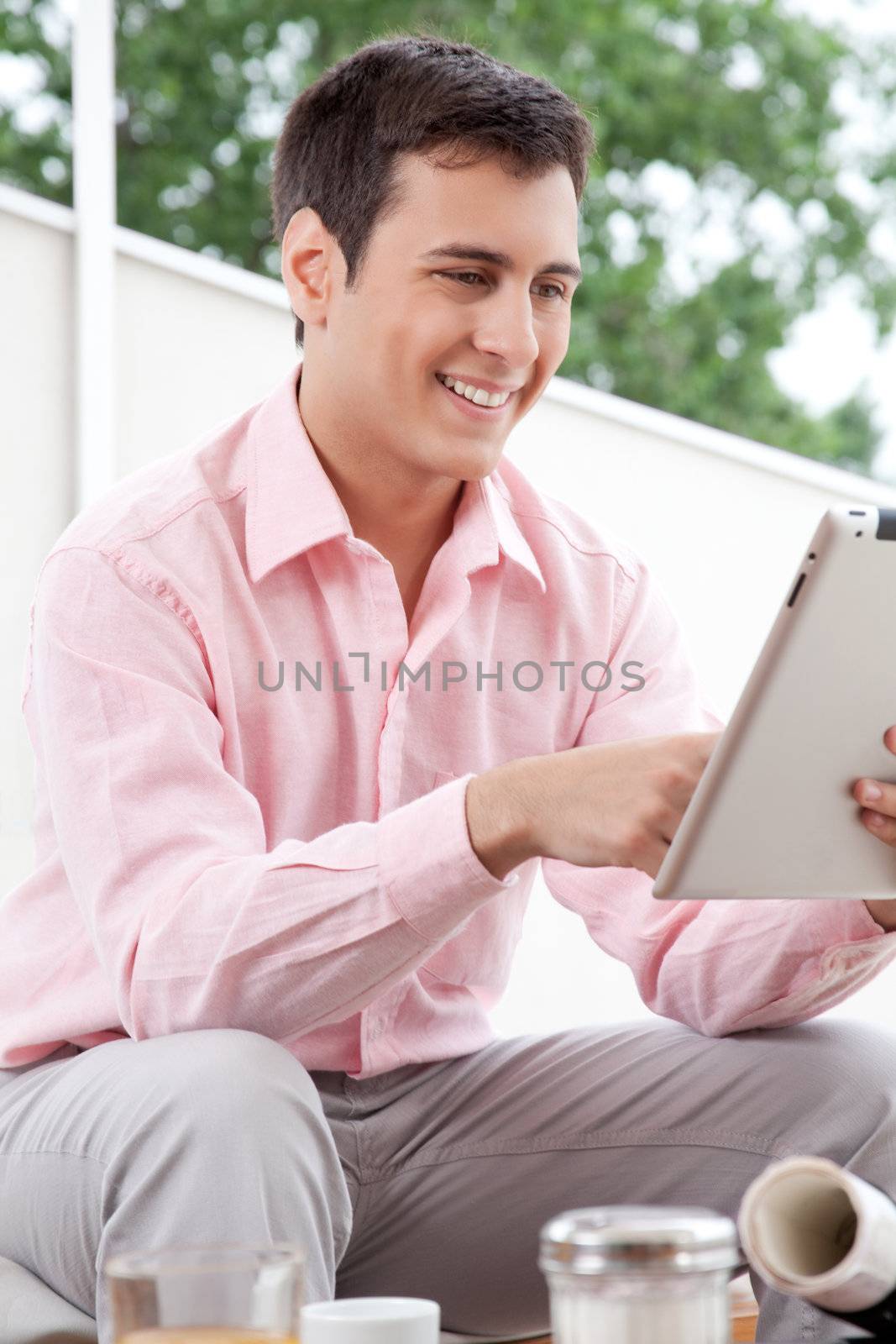 Happy young architect using digital tablet.