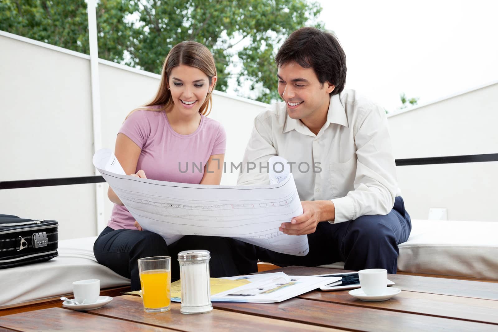 Female Looking At House Plan by leaf