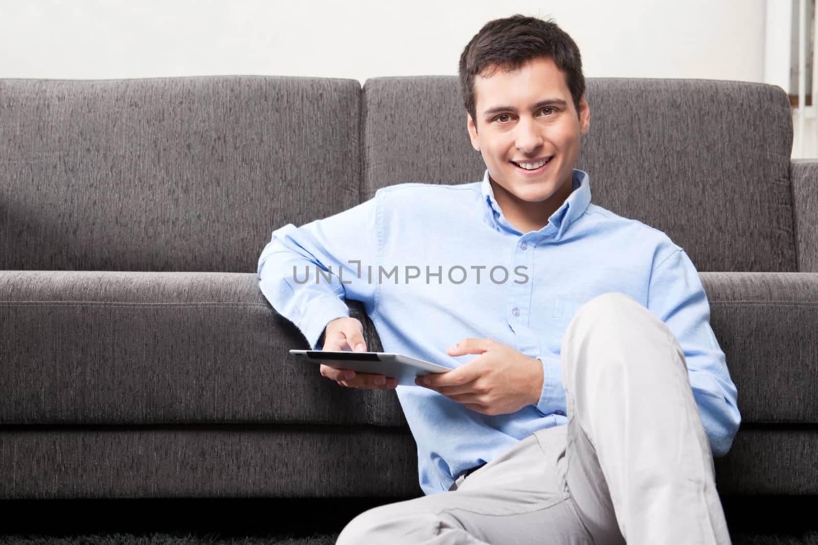 Young Man Holding Digital Tablet by leaf