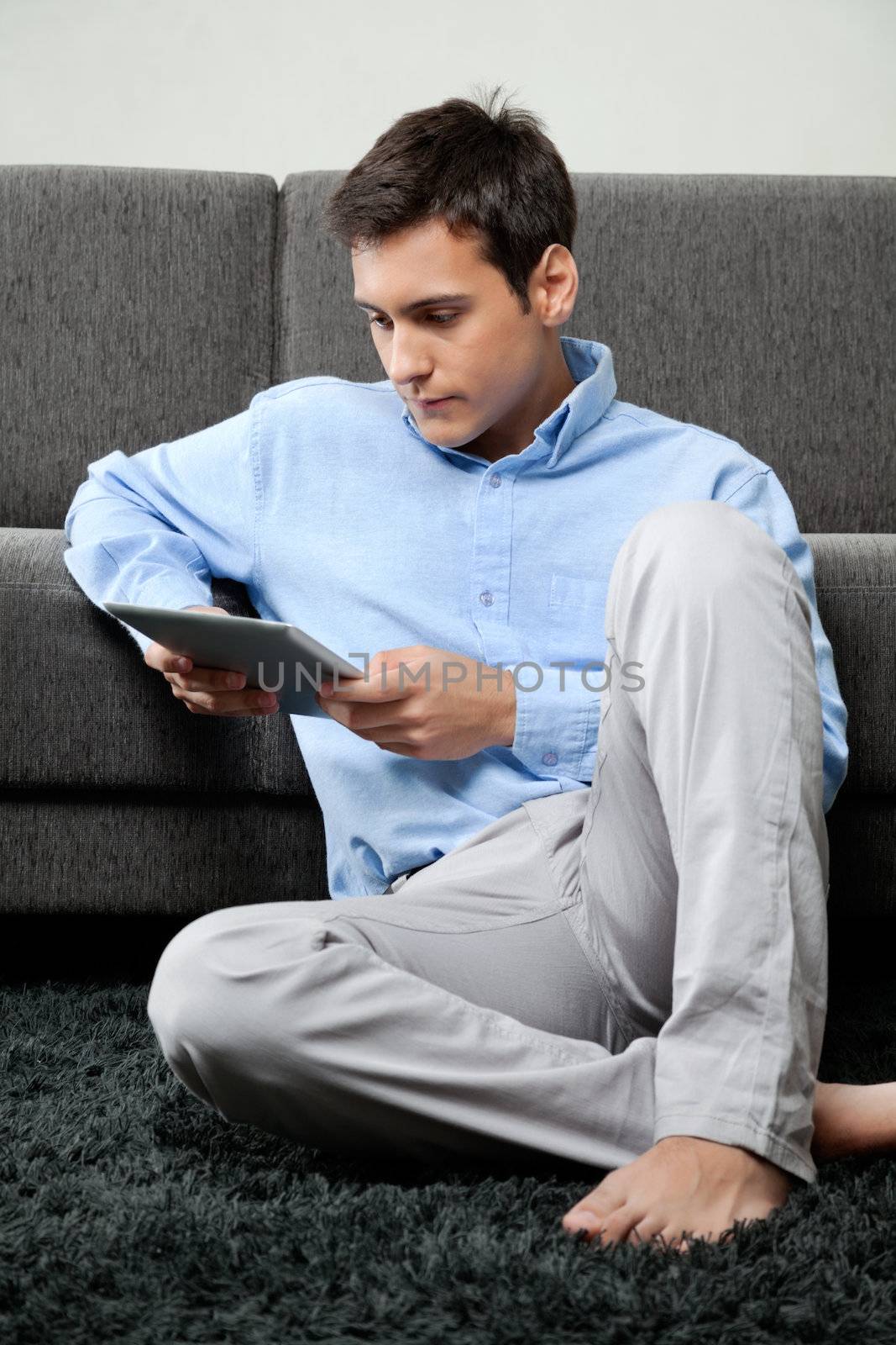 Relaxed Man Using Digital Tablet by leaf