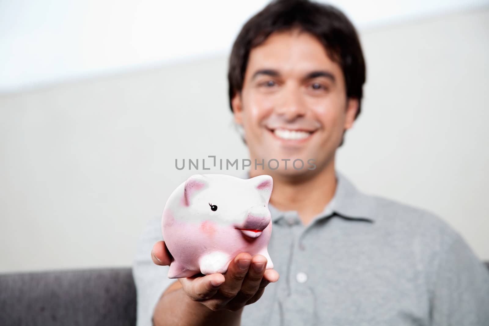 Man Holding Piggy Bank by leaf
