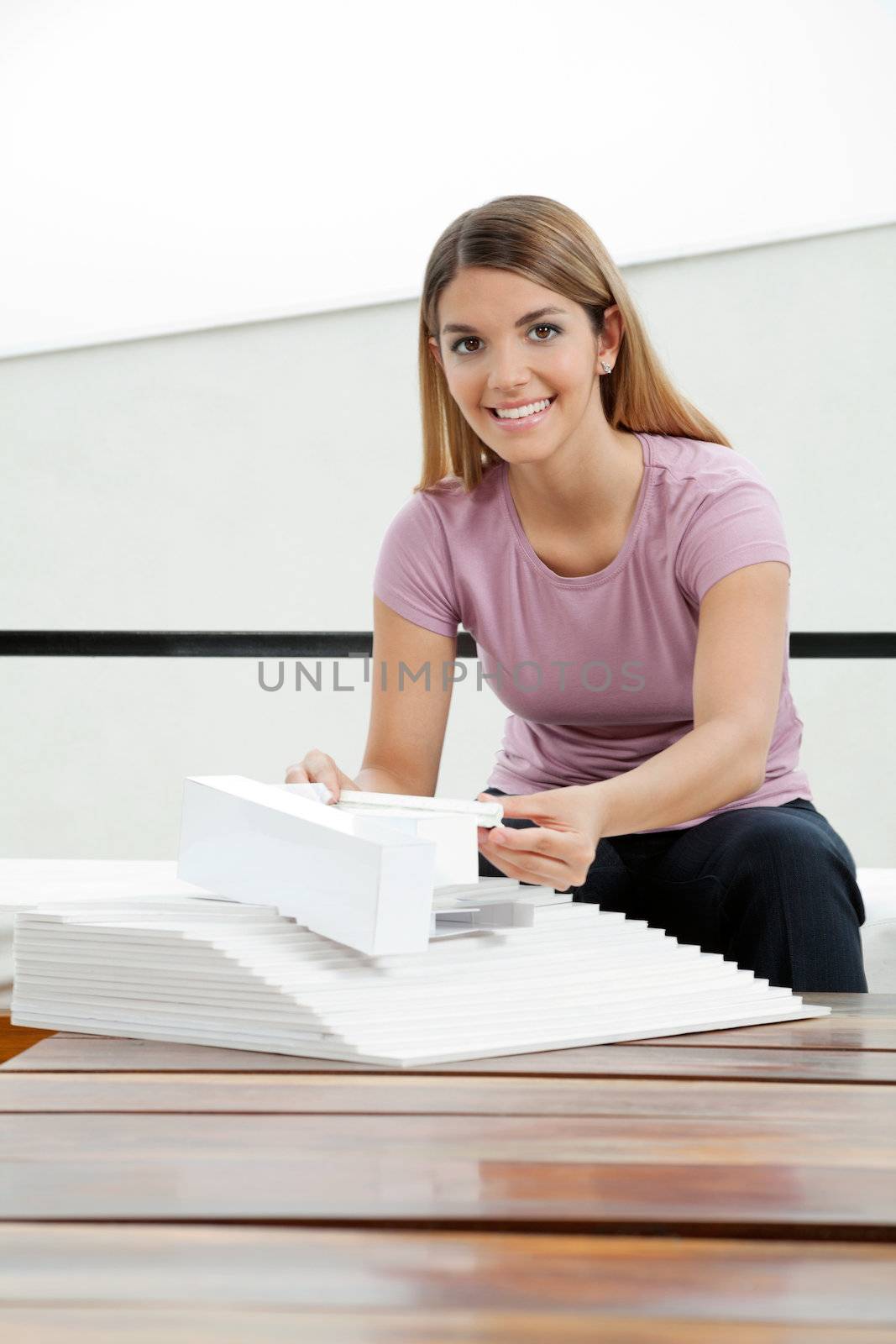 Portrait of an attractive young female architect working on project