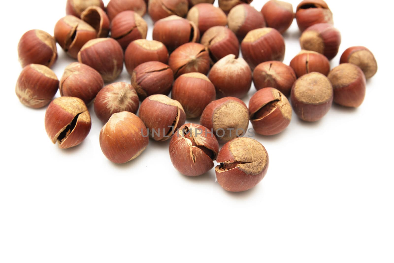 Heap of hazelnuts isolated on white background 