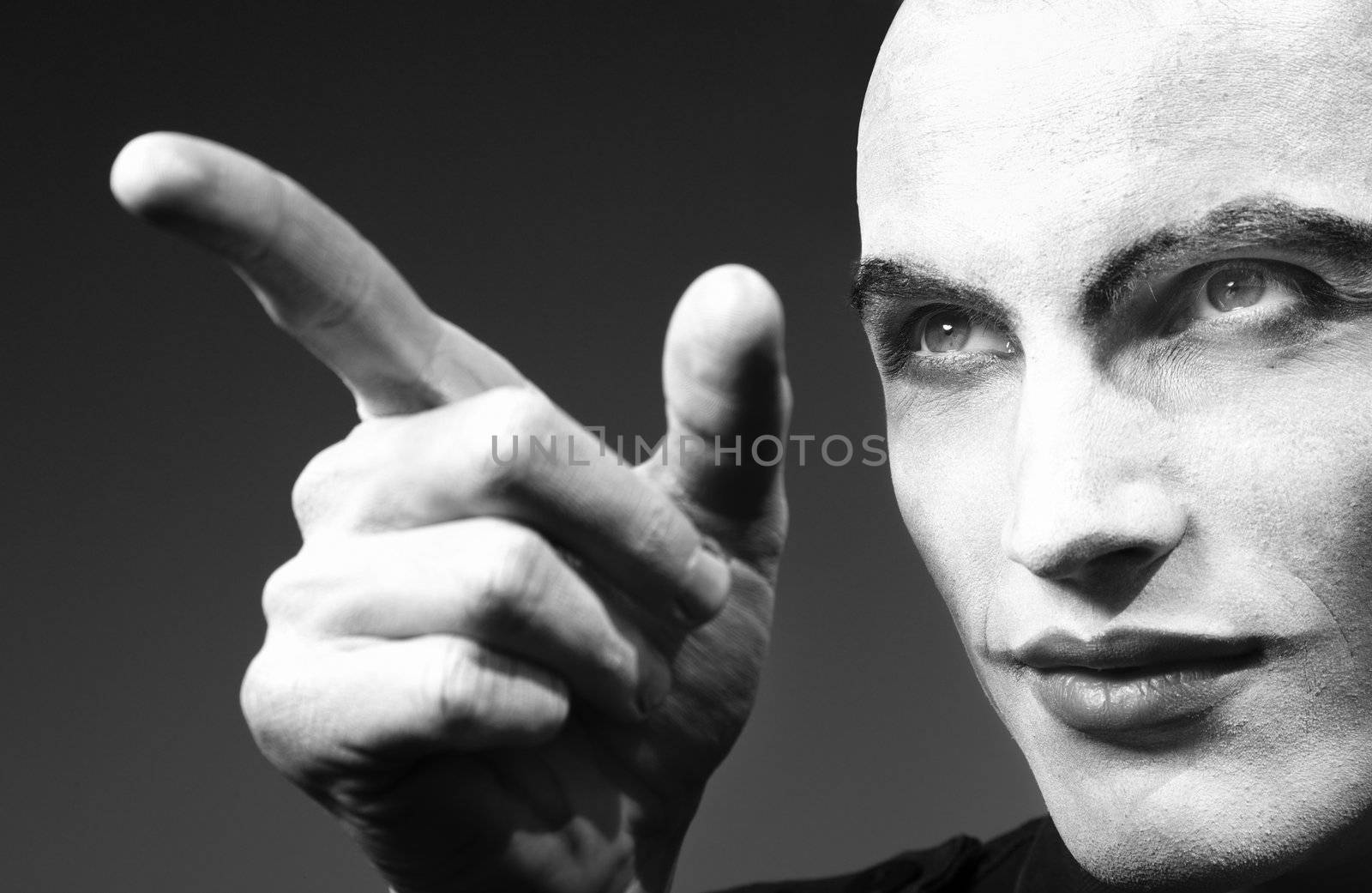 Mad angry funnyman pointing finger. Black and white photo. Artistic darkness added